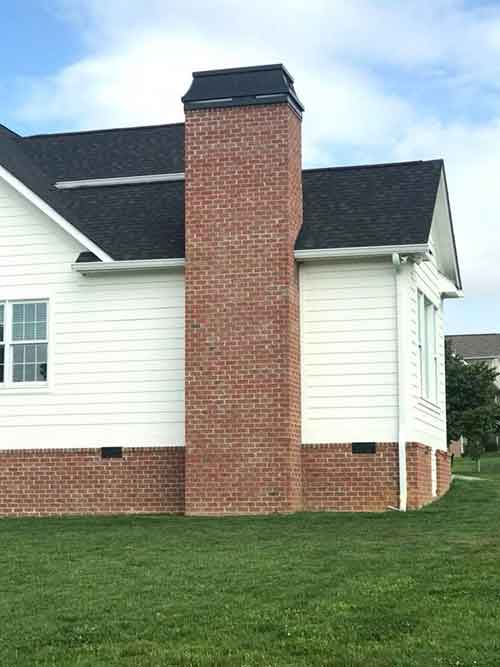 Nice white vinyl home with chimney and custom cap roof is black  asphalt nice clean yard - Request an Appointment