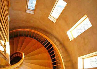 Stucco walls with winding staircase and windows