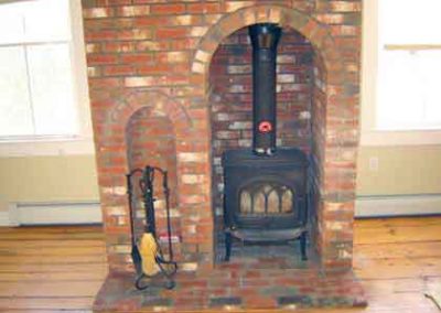 Custom Brick Design with setback for standing fireplace Windows on each side and tools