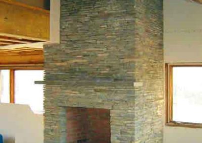 Custom Fireplace Design - stacked stone with limestone chipped mantle and hearth windows on each sideStowe, Vermont