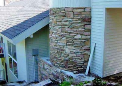 Custom Stone - rounded stacked stone for bottom of turret on side of home
