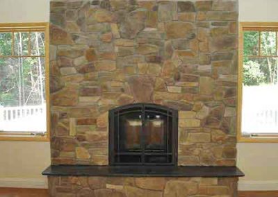 Built in Fireplace Cultured Stone hearth is built up-windows on each side of fireplace